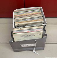 Box and bag filled with vinyl LP records