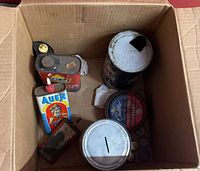 Top view of all tins inside cardboard box
