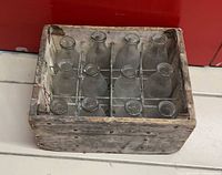 Top view of wood crate holding 12 glass bottles