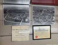 Two aerial photographs and two framed certificates laid out on floor