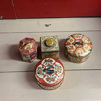Group shot of all four lithographed biscuit tins
