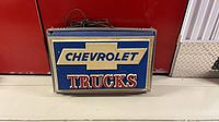 Front view of Chevrolet Trucks illuminated sign showing graphics and frame