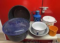 All enamelware pieces grouped on table