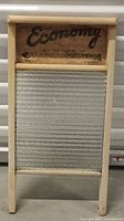 Full view of antique wooden-framed glass washboard with ridged clear glass cleaning surface