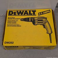 Closed yellow DeWalt box displaying model number DW252, 6.0 amps indication and heavy duty drywall screwdriver printed on front.