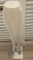 Front view of white female mannequin lower half standing on square metal base, approximately 45.5 inches tall. Shows smooth surface and slight wear marks.