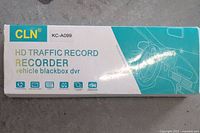 Box labeled 'CLN KC-A099 HD Traffic Record Recorder vehicle blackbox dvr' with graphics of a car interior steering wheel.