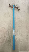 Full length view of the Ideal aluminum EMT bender with blue handle, showing general condition and structure