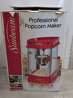 Box of Sunbeam Professional Popcorn Maker, showing branding, photo of product and product title.
