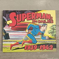 Cover of the book titled 'Superman: The Dailies 1939-1942' depicting Superman running, indicating the date range of strips included.