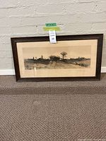 Framed etched artwork titled 'Evening Shadows' by H.M. Rosenberg, resting against a wall on carpeted floor with visible tape showing dimensions 29" x 15"