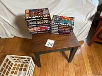 Two stacks of trade paperbacks on small table showing overall quantity and size