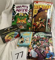All five items laid out: three games and two graphic novels