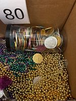 Box interior showing mix of bead necklaces and coins