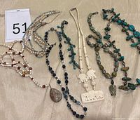 All eight necklaces and pendants arranged together