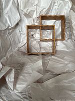 Front view of connected square wood shelf showing overall shape