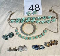 All items in lot laid out showing necklaces, bracelets and multiple earring pairs