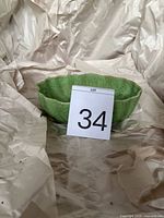 Overall view of green speckled scalloped planter with lot card
