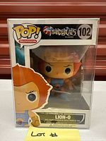 Front view of Funko Pop Lion-O #102 in protective case