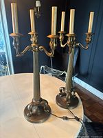Two vintage 5-arm candelabra style electric lamps on a white table, showing overall look and size.