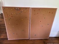 Two cork bulletin boards side by side showing full view