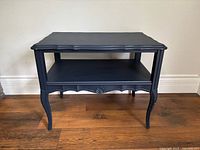 Full view of navy blue French Provincial side table front and top