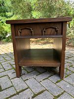 Front view of Lane side table showing decorative front and open shelf