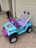 Front left overview of Disney Frozen Power Wheels Jeep ride-on car