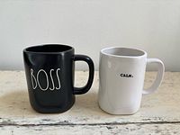 Front view of both mugs showing text designs