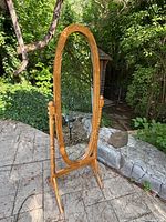 Front view of oak cheval floor mirror