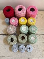 All 16 spools and balls arranged in rows showing colours and relative sizes