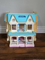 Front view of Fisher-Price Loving Family Dream Dollhouse showing full structure and colors