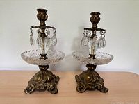 Full view of both brass and crystal candle holders