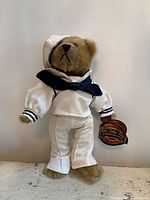 Full view of teddy bear in sailor outfit with tag attached