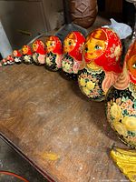 Line of nested dolls arranged largest to smallest