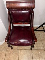 Front view of cherry wood chair with burgundy leather seat and back
