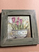 Floral painting with calla-like flowers in decorative pot, green wood frame