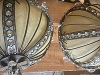 Top view of both spherical chandeliers showing metal ribs and crystal accents