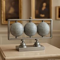 Front view of silver frame with three globes on base