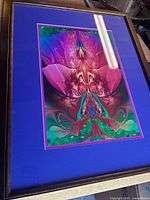 Framed canvas print with blue mat and wooden frame full view