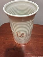 Side view showing ribbed body and red maker’s mark