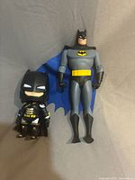 Both Batman figures side by side showing size contrast