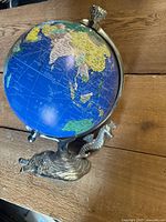 Full view of globe on dragon base