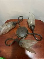 Full view of three-light fixture showing overall design and bronze frame