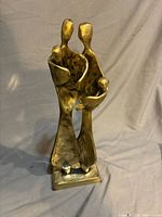 Front view of brass family sculpture