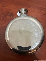 Front view showing embossed brand and polished steel surface