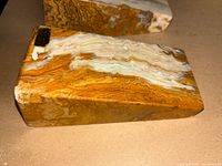 Side view showing layered onyx striations and chipped corner