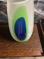 Full view of vase showing green and blue oval decoration