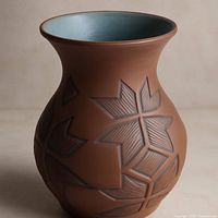 Full view of vase front showing carved pattern and interior glaze