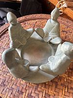 Angled view showing bowl and all four seated figures